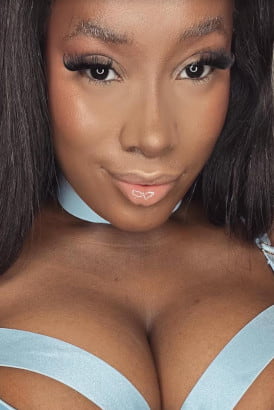 Close up photo of a very busty petite black girl